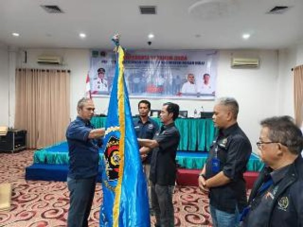 Amin Syukri menerima pataka PWI dari Wakil Ketua Bidang Organisasi PWI Riau, Bambang Irawan Syaputra (kiri), Selasa (5/11/2024). (istimewa)